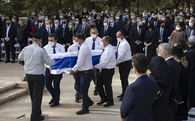 People carry the coffin of Aura Herzog, wife of late president Chaim Herzog, and mother of current President Isaac Herzog, during her funeral at Mount Herzl cemetery in Jerusalem on January 12, 2022. (Olivier Fitoussi/Flash90)