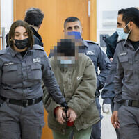 A woman accused of contacting a foreign agent from Iran, arrives for a court hearing in the Jerusalem District Court, January 20, 2022. (Yonatan Sindel/Flash90)