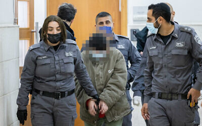 A woman accused of contacting a foreign agent from Iran, arrives for a court hearing in the Jerusalem District Court, January 20, 2022. (Yonatan Sindel/Flash90)