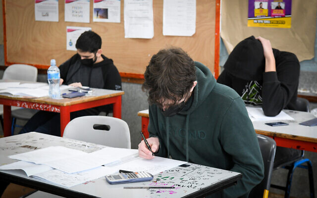 High school students take a test at a school in the central city of Yehud on January 20, 2022. (Yossii Zeliger/Flash90)