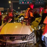 Rescue workers try and free two people trapped in their vehicle following a fatal traffic accident near Ramat Gan on January 18 2022 (Magen David Adom)
