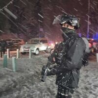 An Israeli policeman confronts rioters in East Jerusalem during a rare snow storm on January 276, 2022 (Israel Police)