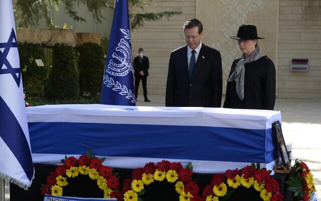 President Isaac Herzog and his wife Michal attend the funeral of his mother Aura Herzog at Mount Herzl national cemetery in Jerusalem, January 12, 2022. (Amos Ben Gershom/GPO)