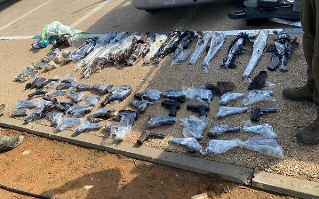 Dozens of guns recovered by Israeli soldiers and police that were allegedly smuggled into Israel from Jordan, on January 25, 2022. (Israel Defense Forces)