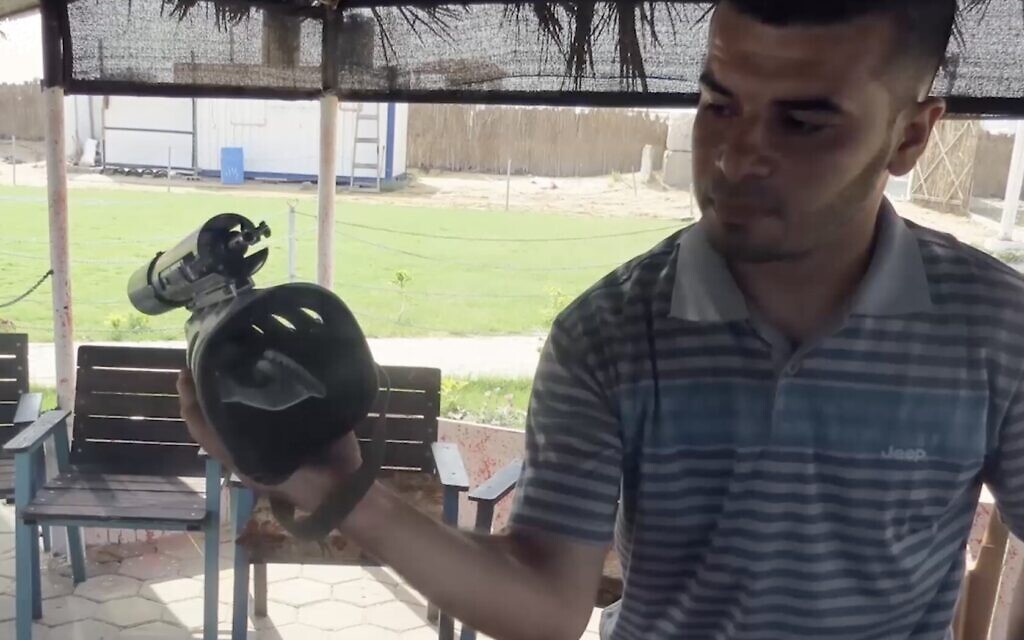 A Hamas operative holds up a harness the terror group says was on a dolphin that it believes was being used by Israel, from a video released by Hamas on January 8, 2022. (Screenshot)
