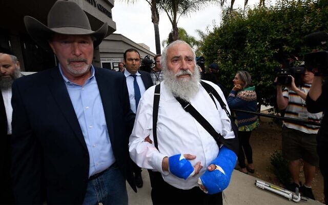 Rabbi Yisroel Goldstein, right, walks with Poway mayor Steve Vaus, left, as he arrives for a news conference at the Chabad of Poway synagogue, shortly after a deadly shooting at the congregation, April 28, 2019. (AP Photo/Denis Poroy)