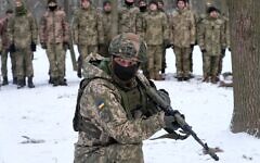 An instructor trains members of Ukraine's Territorial Defense Forces, volunteer military units, in a city park in Kyiv, Ukraine, January 22, 2022. (AP Photo/Efrem Lukatsky)