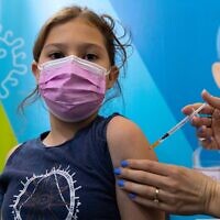 A child receives a COVID-19 vaccine in Jerusalem, December 16, 2021. (Olivier Fitoussi/Flash90)