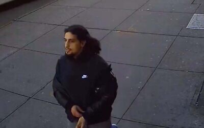 The suspect in a hate crime against a Jewish man in Brooklyn in footage released by the NYPD. (Screenshot)