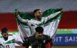 Iranian soccer players celebrate qualifying for the 2022 World Cup after defeating Iraq, at the Azadi stadium in Tehran, Iran, January 27, 2022. (AP Photo/Vahid Salemi)