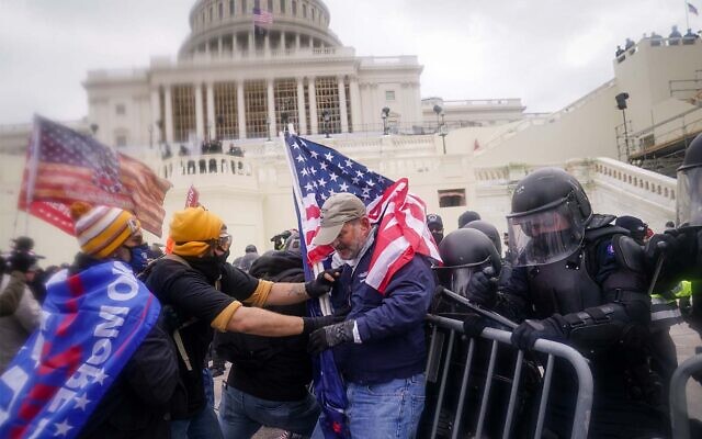 Rioters try to break through a police barrier at the Capitol in Washington on January 6, 2021. (AP Photo/John Minchillo, File)