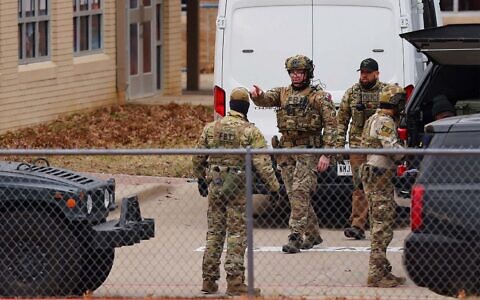 SWAT team members deploy near Congregation Beth Israel Synagogue during a hostage situation in Colleyville, Texas, January 15, 2022. (Andy Jacobsohn/AFP)