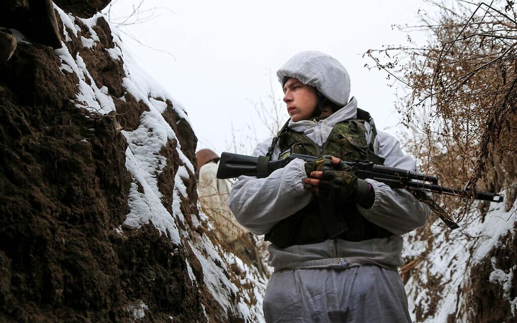 A serviceman stands in a trench on the territory controlled by pro-Russian militants near the frontline with Ukrainian government forces in Slavyanoserbsk, Luhansk region, eastern Ukraine, on January 25, 2022. (AP Photo/Alexei Alexandrov)