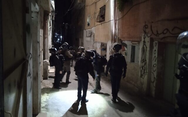 Police officers collect evidence in East Jerusalem's Shuafat refugee camp, after a suspected murder, on January 13, 2022. (Israel Police)