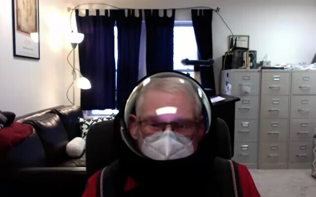 Ferris State University professor Barry Mehler wearing an astronaut helmet in a video he made for students. (Screenshot)