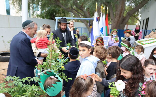 Rabbi Levi Duchman, Israeli consul general in Dubai Ilan Sztulman and children at a Tu Bishvat tree planting event in the UAE. (Courtesy)