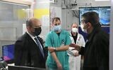 Prime Minister Naftali Bennett (right) tours Sheba Medical Center in Ramat Gan, on January 4, 2021. (Amos Ben Gershom/GPO)