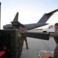 Ukrainian servicemen move US-made FIM-92 Stinger missiles and other military assistance shipped from Lithuania to Boryspil Airport in Kyiv, on February 13, 2022. (Sergei Supinsky/AFP)