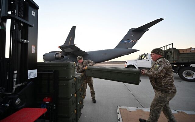 Ukrainian servicemen move US-made FIM-92 Stinger missiles and other military assistance shipped from Lithuania to Boryspil Airport in Kyiv, on February 13, 2022. (Sergei Supinsky/AFP)