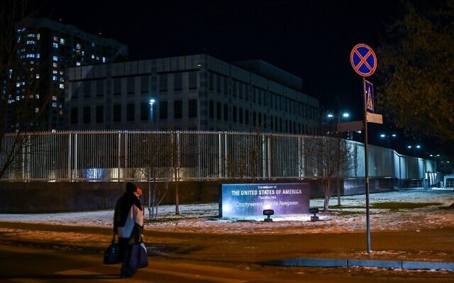 A woman passes by the closed US embassy in Kyiv after operations were moved to Lviv, on February 14, 2022. (Aris Messinis/AFP)