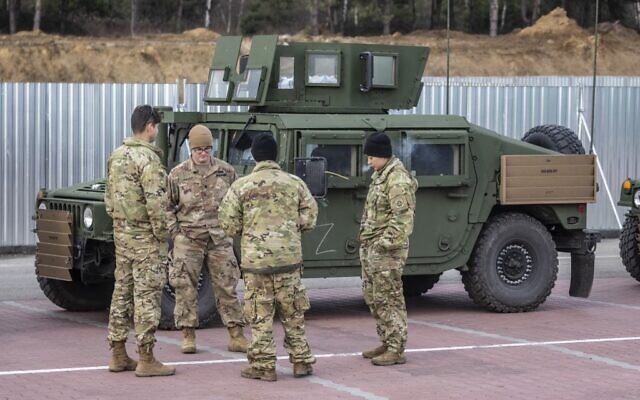 US soldiers stand next to their vehicles at a temporary base installed close to the Rzeszow-Jasionka Airport, south eastern Poland, February 16, 2022. (Wojtek RADWANSKI / AFP)