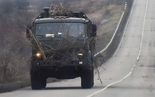 A Russian military truck moves along a road in Russia’s southern Rostov region, which borders the self-proclaimed Donetsk People’s Republic, on February 23, 2022. (Photo by STRINGER / AFP)