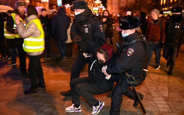 Police officers detain a woman during a protest against Russia's invasion of Ukraine in Moscow, on February 24, 2022. (Kirill Kudryavtsev/AFP)