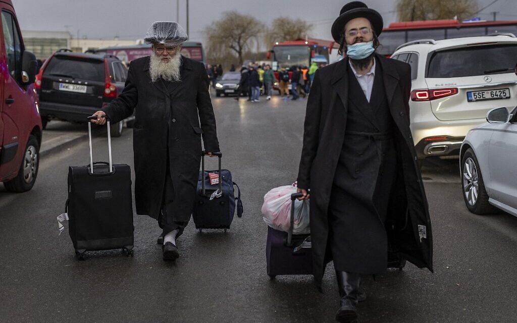Two Orthodox Jews are seen arriving at the Medyka pedestrian border crossing in eastern Poland, fleeing the conflict in their country, one day after Russia launched a military attack on its neighbor Ukraine, February 25, 2022. (Wojtek Radwanski/AFP)