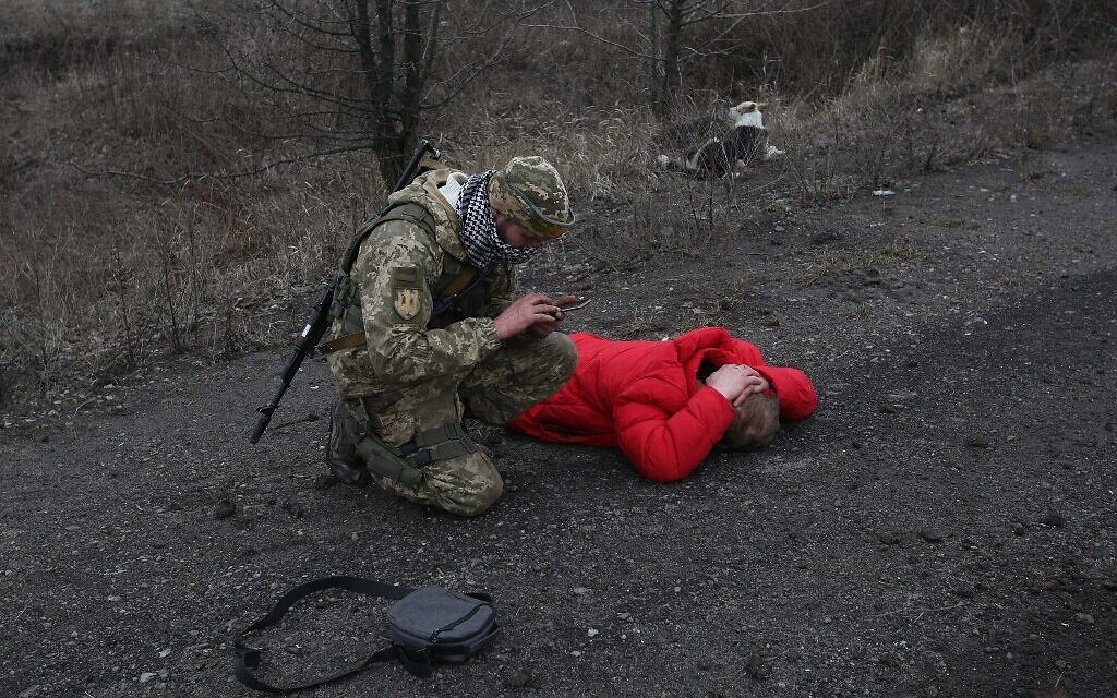 A Ukrainian serviceman checks on a man who was acting suspicious not far from the positions on Ukraine's service members in Lugansk region on February 26, 2022. (Anatolii Stepanov / AFP)