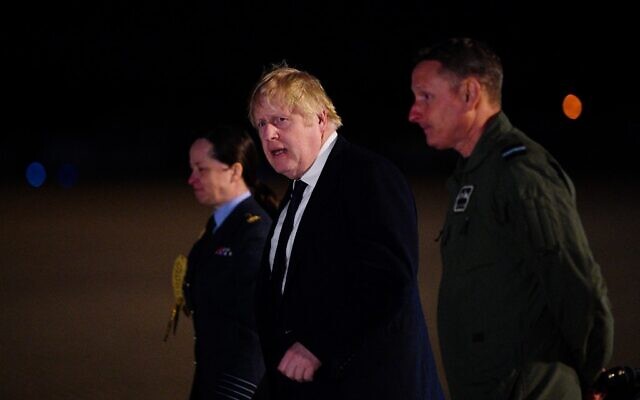 Prime Minister Boris Johnson (center) meets with military personnel at RAF Brize Norton, northwest of London, on February 26, 2022, to thank them for their ongoing work facilitating military support to Ukraine and NATO. (Ben Birchall/Pool/AFP) Prime Minister Boris Johnson (center) meets with military personnel at RAF Brize Norton, northwest of London, on February 26, 2022, to thank them for their ongoing work facilitating military support to Ukraine and NATO. (Ben Birchall/Pool/AFP)