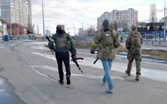 Ukrainian Territorial Defense fighters patrol the streets after a fight in Kharkiv, on February 27, 2022. (Sergey Bobok/AFP)