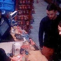 This file video grab taken from a CCTV camera at a petrol station in Ressons, North of Paris, on November 11, 2015, shows Salah Abdeslam (R), a suspect in the Paris attack of November 13, and Mohammed Abrini (C) buying goods (OFF / AFP)