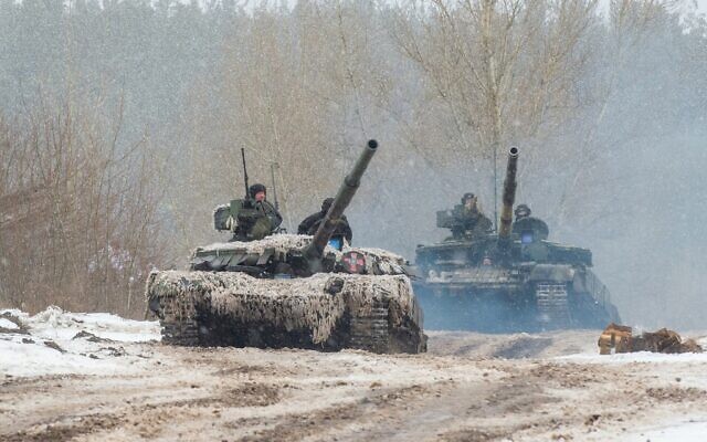 Ukrainian Military Forces servicemen of the 92nd mechanized brigade use tanks, self-propelled guns and other armored vehicles to conduct live-fire exercises near the town of Chuguev, in the Kharkiv region, on February 10, 2022 (Sergey Bobok/AFP)