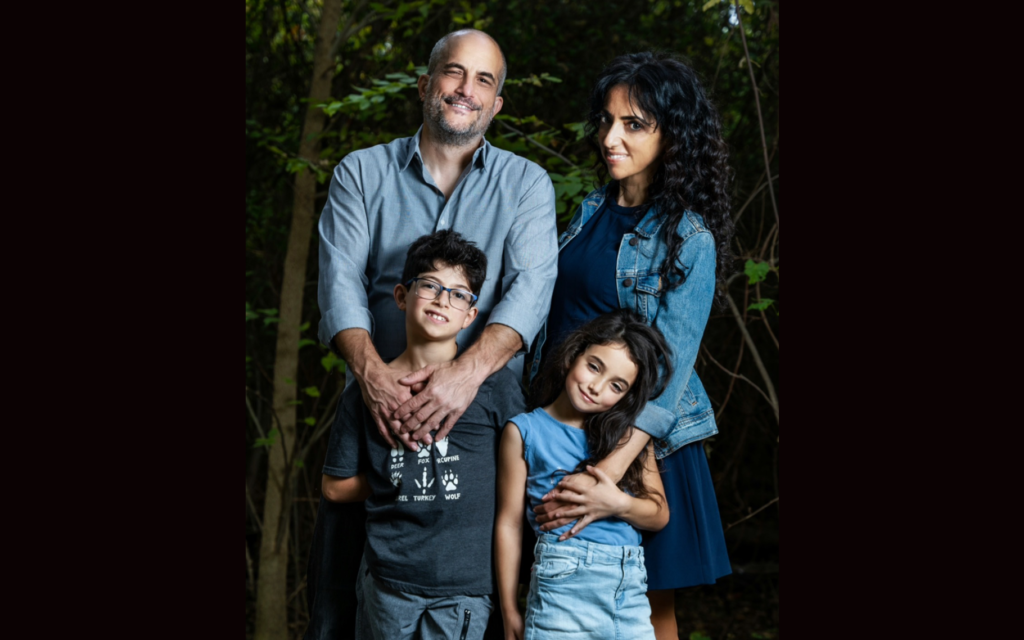 Huwaida Arraf (right) poses with her husband, Adam Shapiro (left), and their two children. (Courtesy)