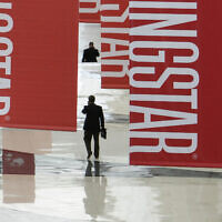 Attendees of a Morningstar investment conference walk beneath banners at the McCormick Center in Chicago, on June 24, 2010. (AP Photo/M. Spencer Green, File)