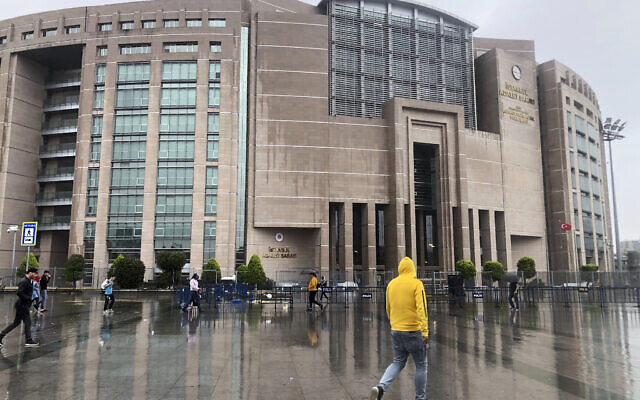 People walk outside the Justice Palace, in Istanbul, Sept. 20, 2019. (AP Photo/Mehmet Guzel)