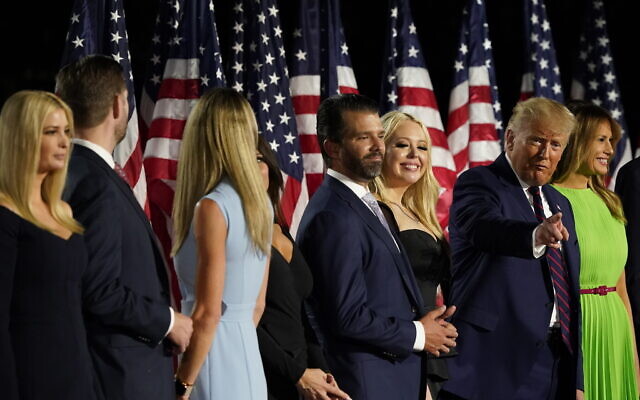 From left, Ivanka Trump, Eric and Lara Trump, Kimberly Guilfoyle and Donald Trump Jr., Tiffany Trump, President Donald Trump and first lady Melania Trump and Barron Trump stand on stage on the South Lawn of the White House on the fourth day of the Republican National Convention, Thursday, Aug. 27, 2020, in Washington. (AP Photo/Alex Brandon)
