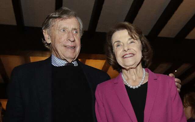 In this November 6, 2018 file photo, US Sen. Dianne Feinstein (right) smiles next to husband Richard Blum at an election night event in San Francisco. (AP Photo/Jeff Chiu, File)