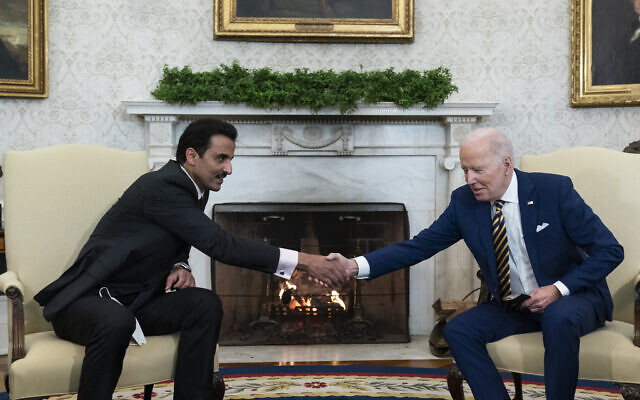 US President Joe Biden, right, shakes hands with the Qatar's Emir Sheikh Tamim bin Hamad Al Thani in the Oval Office of the White House, January 31, 2022, in Washington. (AP Photo/ Alex Brandon/ File)