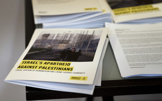 Copies of Amnesty International’s report ‘Israel’s Apartheid Against Palestinians,’ at a press conference in Jerusalem, Tuesday, Feb. 1, 2022. (AP/Maya Alleruzzo)