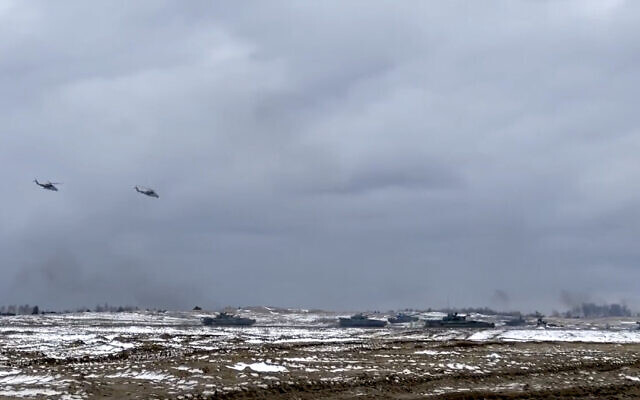 In this photo taken from video and released by the Russian Defense Ministry Press Service on February 2, 2022, Russian and Belarusian tanks and military helicopters attend a joint military drills at Brestsky firing range, Belarus. (Russian Defense Ministry Press Service via AP)