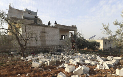 People check a destroyed house after an operation by the US military in the Syrian village of Atmeh, in Idlib province, Syria, on Thursday, February 3, 2022. (AP Photo/Ghaith Alsayed)