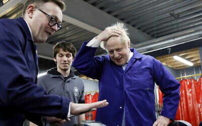 British Prime Minister Boris Johnson visits the technology center at Hopwood Hall College, in Middleton, Greater Manchester, England, on Thursday, February 3, 2022. (Jason Cairnduff/Pool via AP)