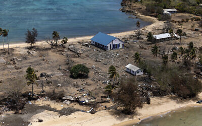 Debris from damaged building and trees are strewn around on Atata Island in Tonga, on January 28, 2022. (POIS Christopher Szumlanski/ Australian Defence Force via AP)