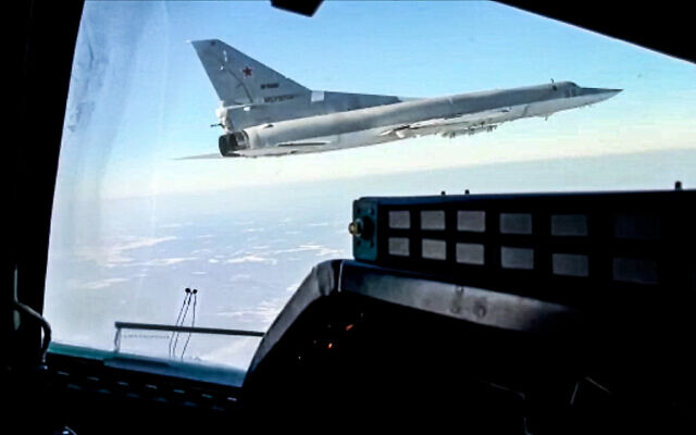 In this photo taken from video and released by the Russian Defense Ministry Press Service on February 5, 2022, a Tu-22M3 bomber of the Russian air force is seen from the cockpit of another such plane during a training flight. (Russian Defense Ministry Press Service via AP)