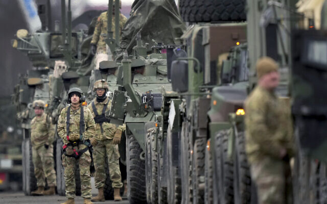 Soldiers of the 2nd Cavalry Regiment line up vehicles at the military airfield in Vilseck, Germany, Feb. 9, 2022 as they prepare for the regiment’s movement to Romania loading of Stryker combat vehicles for their deployment to support NATO allies and demonstrate U.S. commitment to NATO Article V (AP Photo/Michael Probst)