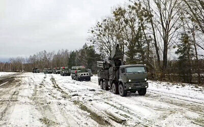 In this photo taken from video provided by the Russian Defense Ministry Press Service on Feb. 10, 2022, combat crews of the S-400 air defense system drive to take up combat duty at the training ground in the Brest region during the Union Courage-2022 Russia-Belarus military drills in Belarus. (Russian Defense Ministry Press Service via AP)
