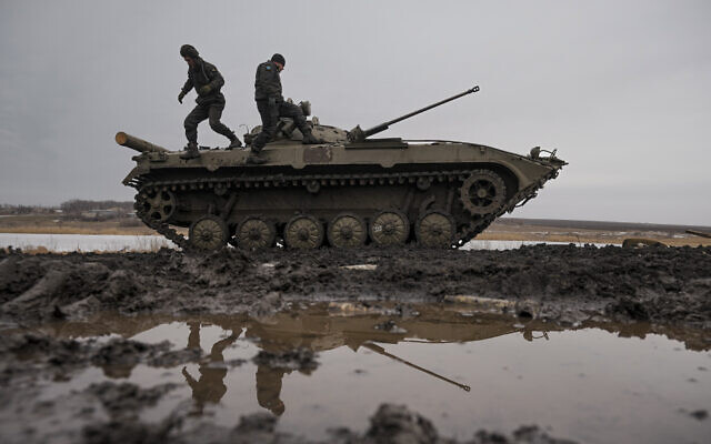 Ukrainian servicemen walk on an armored fighting vehicle during an exercise in a Joint Forces Operation controlled area in the Donetsk region, eastern Ukraine, Feb. 10, 2022.(AP/Vadim Ghirda)