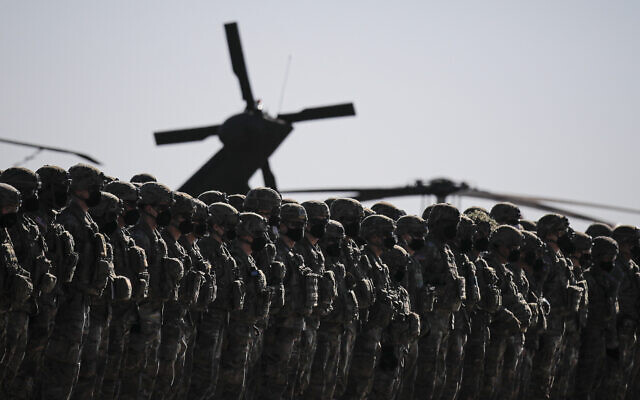 US soldiers line up during the visit of NATO Secretary General Jens Stoltenberg at the Mihail Kogalniceanu airbase, near the Black Sea port city of Constanta, eastern Romania, February 11, 2022. (AP Photo/Andreea Alexandru)