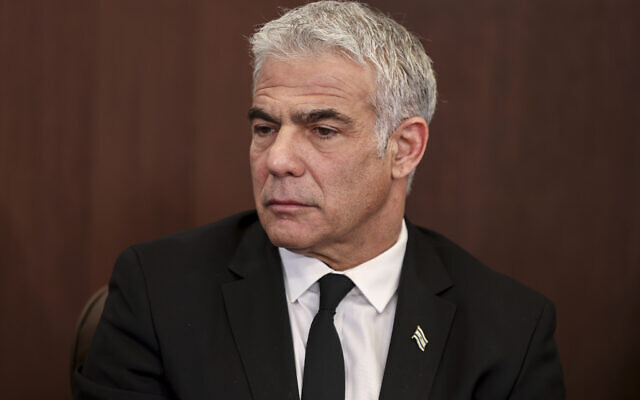 Foreign Minister Yair Lapid speaks at a weekly cabinet meeting, at the Prime Minister's office in Jerusalem, February 13, 2022. (Menahem Kahana/Pool via AP)